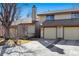 Charming exterior view of townhome with attached garage, neutral color, and well-maintained landscape at 4203 Owens St, Wheat Ridge, CO 80033