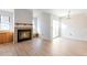 Bright living room with vaulted ceilings, fireplace, wood floors, and sliding glass doors to the outside at 4203 Owens St, Wheat Ridge, CO 80033