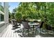 Spacious back deck with dining table and chairs overlooking a lush, green yard at 6401 S Forest St, Centennial, CO 80121