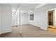 Open unfinished basement area with carpet, support beams, and small window at 6401 S Forest St, Centennial, CO 80121