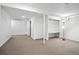Unfinished basement with carpeted floors, white walls, support beams and utility access at 6401 S Forest St, Centennial, CO 80121
