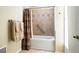 Bathroom showcasing a tiled shower-tub combination and towel racks at 6401 S Forest St, Centennial, CO 80121