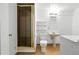 Basement bathroom with standing shower, single sink and tile flooring at 6401 S Forest St, Centennial, CO 80121