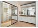 Bathroom with walk-in closet, and dual sinks on a granite countertop vanity at 6401 S Forest St, Centennial, CO 80121