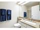 Bathroom featuring granite countertops, decorative mirror, and a glass shower at 6401 S Forest St, Centennial, CO 80121