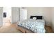 Bright bedroom with floral patterned bedding and en-suite bathroom access at 6401 S Forest St, Centennial, CO 80121