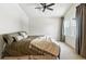 Bedroom features a ceiling fan, neutral carpet, and natural light from the window at 6401 S Forest St, Centennial, CO 80121