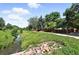 Picturesque view of community creek surrounded by green grass, rocks and trees at 6401 S Forest St, Centennial, CO 80121