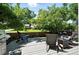 Backyard deck with a grill, patio set, and lush trees at 6401 S Forest St, Centennial, CO 80121