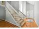 Bright entryway features hardwood floors, a modern staircase, and a neutral color palette at 6401 S Forest St, Centennial, CO 80121