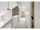Hallway featuring decorative stone detail, carpeted floors, and natural light at 6401 S Forest St, Centennial, CO 80121