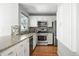 Updated kitchen featuring stainless steel appliances, white cabinets, and granite countertops at 6401 S Forest St, Centennial, CO 80121