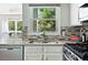 Bright kitchen featuring granite countertops, stainless steel appliances, and a window view at 6401 S Forest St, Centennial, CO 80121