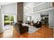Inviting living room featuring a stone fireplace, hardwood floors, and an open layout to the kitchen at 6401 S Forest St, Centennial, CO 80121