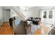 Open-concept living room with staircase, hardwood floors, and comfortable seating arrangement at 6401 S Forest St, Centennial, CO 80121