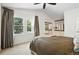 Bedroom with large windows, carpet, ceiling fan, and ensuite bath with dual sinks and walk-in closet at 6401 S Forest St, Centennial, CO 80121