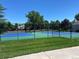 Community tennis courts with new blue and green surfaces, surrounded by mature trees and greenery at 6401 S Forest St, Centennial, CO 80121