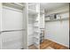 Walk-in closet features built-in shelving and hardwood floors at 6401 S Forest St, Centennial, CO 80121