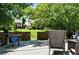 View of backyard with fence, mature trees, and seating area at 6401 S Forest St, Centennial, CO 80121
