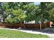 View of the landscaped yard with mature trees and fence at 6401 S Forest St, Centennial, CO 80121