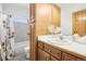 Clean bathroom with a shower/tub combo and wood cabinets at 370 Terra Vista St, Brighton, CO 80601