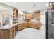 Kitchen with wood cabinets, granite countertops, and stainless steel appliances at 370 Terra Vista St, Brighton, CO 80601