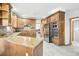 Large kitchen with wood cabinets, granite countertops, and stainless steel appliances at 370 Terra Vista St, Brighton, CO 80601