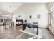 Bright living room with a fireplace, wood floors, and large windows at 370 Terra Vista St, Brighton, CO 80601