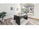 Home office with wood floors, large window, and a desk at 370 Terra Vista St, Brighton, CO 80601