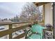 A balcony with a small table, two chairs, and a view of the street at 1358 S Irving St # 53, Denver, CO 80219