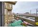 A balcony with a small table, two chairs, and a view of the street at 1358 S Irving St # 53, Denver, CO 80219