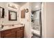 Bathroom featuring a single sink vanity and a tiled walk-in shower at 1358 S Irving St # 53, Denver, CO 80219