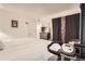 Bedroom featuring hardwood floors, neutral walls, a TV, and plenty of natural light at 1358 S Irving St # 53, Denver, CO 80219