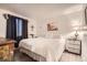 Bedroom with neutral walls, wood floor, large windows, and a queen sized bed at 1358 S Irving St # 53, Denver, CO 80219