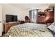 Bedroom with a plaid comforter, a large window, and hardwood floors at 1358 S Irving St # 53, Denver, CO 80219