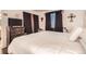 Bedroom with white walls, hard wood floors, a television, and black out curtains at 1358 S Irving St # 53, Denver, CO 80219