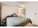 Bedroom with a plaid comforter and a large window that provides lots of natural light at 1358 S Irving St # 53, Denver, CO 80219