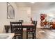 Dining area with hardwood floors and decorative artwork on white walls at 1358 S Irving St # 53, Denver, CO 80219
