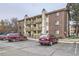Exterior view of the condominium building with brick facade and multiple levels of patios at 1358 S Irving St # 53, Denver, CO 80219