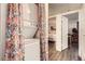 Compact laundry area with a stacked washer and dryer hidden behind a floral curtain at 1358 S Irving St # 53, Denver, CO 80219