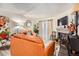 Bright living room showcasing cozy leather sofas, decorative fireplace, and sunny windows at 1358 S Irving St # 53, Denver, CO 80219