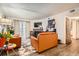 Living area featuring a decorative fireplace, leather sofas, and natural light at 1358 S Irving St # 53, Denver, CO 80219