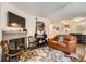 Comfortable living room with a brick fireplace, leather couch and decorative rug at 1358 S Irving St # 53, Denver, CO 80219