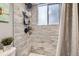 Shower with tile surround, window, and adjustable shower head at 1358 S Irving St # 53, Denver, CO 80219