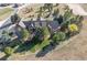 Expansive property featuring a luxurious home nestled amongst mature trees and a horse pasture at 9250 Steeplechase Dr, Franktown, CO 80116