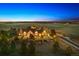 Luxury home with expansive grounds at dusk at 9250 Steeplechase Dr, Franktown, CO 80116