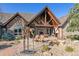 Relaxing outdoor patio featuring a fireplace, pond, comfortable seating, and beautiful stonework at 9250 Steeplechase Dr, Franktown, CO 80116