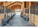 Beautiful equestrian barn with stalls and tack storage creating a functional workspace at 9250 Steeplechase Dr, Franktown, CO 80116