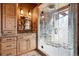 Charming bathroom with a tiled shower featuring a unique forest scene etched in the glass door at 9250 Steeplechase Dr, Franktown, CO 80116