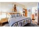 Spacious Primary bedroom with stylish bedding and ensuite bathroom access at 9250 Steeplechase Dr, Franktown, CO 80116
